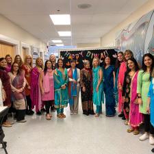 Elementary staff gathered for photo, dressed in traditional attire to celebrate Diwali