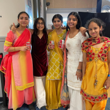 Five middle school girls pose for photo dressed in traditional attire to celebrate Diwali
